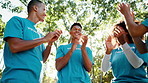 Applause, volunteer and group of people in park for charity event, community service and teamwork. Volunteering, NGO or men with women for collaboration, celebration and low angle outdoor for success