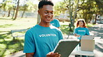 Outdoor, man and volunteer with digital tablet for sign up, NGO and website for community service. Park, people and nonprofit manager with tech for charity project, smile or program for food donation