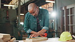 Black man, carpenter and measuring tape at factory for wood, drawing or design at warehouse. Person, tools and pencil with plank, process and creative for furniture, manufacturing or job in workshop
