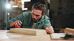 Man, carpenter and measuring tape at workshop for wood, drawing or design process at warehouse. Person, tools and pencil for plank, planning or creative for furniture, manufacturing or job in factory