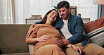 Love, pregnancy and happy couple on sofa with hands on stomach for support, care and conversation at home together. Maternity, future or people in living room with growth, hug and child development