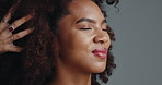 Woman, afro and hands for hairdresser in studio, massage or smile for treatment with results by background. African girl, happy and relax for hair care, grooming or change with eyes closed for beauty