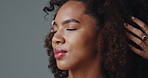 Girl, afro and hands for hairdresser in studio, massage or smile for treatment with results by background. African woman, happy and relax for hair care, grooming or change with eyes closed for beauty