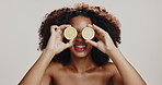 Skincare, beauty and happy woman with lemon in studio for dermatology, diet or nutrition on white background. Citrus fruit, natural cosmetics and organic vitamin c, detox or health with African model