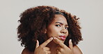 Face, black woman and skincare for acne, checking and skin breakout on white studio background. Portrait, African model and person with cosmetics, blemish and spa treatment for natural beauty