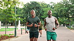 Men, talking and friends with running outdoor for morning routine, marathon challenge or wellness performance. Fitness energy, people and runner club with cardio pace, endurance workout or discussion