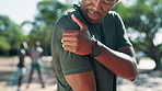 Man, shoulder pain and injury with exercise in park, stress and massage for relief with training in summer. Person, sore muscle and inflammation with worry, frustrated and touch arm for workout