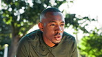 Runner, tired and man on break, breathing and sweating in nature, fitness and outdoor for workout. Park, exhausted and black person with fatigue in morning, exercise and practice for marathon or race