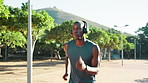 Headphones, running and black man in park for challenge, wellness and fitness. Radio, podcast and African athlete with endurance training, exercise and workout for cardio and jog outdoors in nature