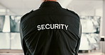 Back, security guard and man in office, video surveillance and computer with safety service. Person, employee and officer in workplace, uniform or control room with inspection, camera and information