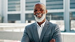 Face, business and mature black man in city, real estate manager or realtor with arms crossed. Portrait, outdoor and confident professional, happy executive and investment property advisor in Ghana
