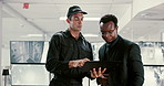 Talking, security guard and men in office, clipboard and communication for safety report. People, coworkers and employees in control room, documents and investigation update with feedback and review