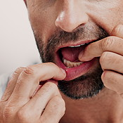 Dental health, hands and man with floss in studio for cleaning, hygiene ...