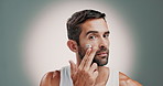 Man, face and cream with skincare for moisturizer, facial treatment or hygiene on a studio background. Portrait, male person or model with lotion, cosmetic product or SPF for skin glow on space