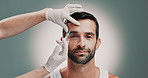 Hands, beautician and man with face injection in studio for skincare, antiaging and collagen. Cosmetic, needle and plastic surgeon with person for facial transformation with filler by gray background