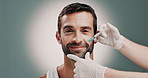 Cosmetologist, hands and face of man with injection in studio for wrinkles, antiaging or facial treatment. Plastic surgery, needle and nurse with male person for filler syringe by gray background.