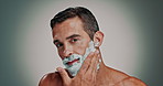Face, man and foam with shaving for skincare, hair removal and facial hygiene for self care. Portrait, person and product with grooming routine, dermatology cream and maintenance in studio background