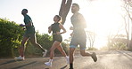 Women, men and running group in street, morning and training for fitness, diversity and wellness in summer. People, friends and outdoor in road for exercise, workout and speed for health at park