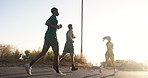 Women, men and running group in street, morning or back for training for fitness, diversity or wellness in summer. People, friends and sunrise in road for exercise, workout and speed for health