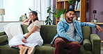 Frustrated couple, ignore or fight with argument on sofa for disagreement or conflict at home. Man, woman or toxic relationship with irritation for breakup, divorce or living room dispute at house