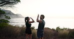 Fitness, couple and high five with teamwork on mountain for achievement, running or workout together in nature. Back view, man and woman with smile or hug for cardio, exercise or training in forest