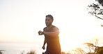 Man, fitness and running with watch in sunset on mountain road for workout, cardio exercise or journey in nature. Male person, athlete or runner with wristwatch for perfomance in outdoor training