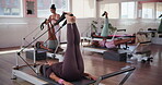 Pilates, reformer and health with woman in class for workout, fitness and balance machine. Exercise, wellness and core strength with people in yoga studio for stretching, self care and flexibility