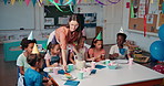 Teacher, children and cake for celebration at school, birthday snack and together for eating dessert. Classroom, woman facilitator and sweet food for education success, academy party and students