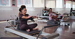 Pilates, machine and workout with woman in class for reformer equipment, fitness and health club. Exercise, wellness and gym with group of people in yoga studio for balance, resistance and lesson