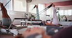 Pilates, class and people on reformer machine for workout with core strength, toning or exercise. Equipment, gym and group of women with body training for fitness activity or challenge in studio.