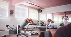 Pilates reformer, core and woman instructor in workout for fitness, body machine or group class. People, training or teaching strength exercise in gym studio for resistance, health or flexibility