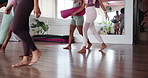 Yoga class, people and legs with walking for fitness, holistic wellness and gear for mindfulness routine. Studio, feet and group of friends with exercise mat, health and mirror reflection by closeup