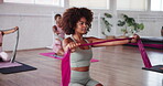 Fitness class, pilates and resistance band with people in studio for exercise or training together. Equipment, stretching and tension with instrcutor in group session at gym for strength workout
