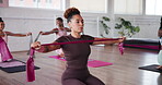 Class, fitness and resistance band with women in gym for challenge or strength training. Elastic, exercise and personal trainer in health club for course or lesson with group of students for wellness