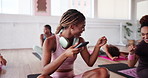 Phone, pilates and fist bump with friends in class for streaming, fitness and teamwork. Social media, workout and wellness with women and gesture in yoga studio for health, exercise and support