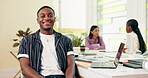 Face, laptop and smile with business man at boardroom table in office for meeting or planning. Computer, confident or happy and design employee in workplace with coworkers for development or research