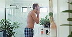 Man, wash face and faucet in bathroom with towel for skincare, hygiene and wellness in morning at house. Person, water and cloth for cleaning, hydration and self care for cosmetics at apartment
