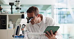 Man, scientist and microscope on tablet in lab for research, studying bacteria and medical results. Male person, biotechnology and digital for experiment notes, growth feedback and sample for vaccine