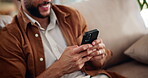 Hands, man and relax with phone at house for browsing social media, communication and reading blog. Happy, male person and mobile with chatting, message to contact and typing feedback of notification