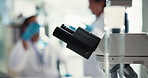 Microscope, closeup and science research in lab for chemical testing, medical experiment and study. Scientist, biotechnology and liquid with healthcare safety, particles evolution and vaccine results