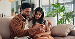 Excited, phone and smile with couple on sofa in living room of home for communication or social media. App, energy or mobile search with man and woman in apartment together for bonding or browsing