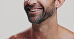Beard, laughing and mouth of man in studio for cosmetics, dermatology or hygiene closeup. Beauty, skincare and teeth of funny model on white background with satisfaction for results or wellness