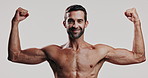 Biceps, face and white background with smile of shirtless man for fitness, masculinity or strength. Arms, exercise and muscle with body of confident model in studio for training or workout results