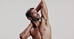 Man, pride and flexing biceps in studio with strong muscles, masculinity and bodybuilding progress. Male person, shirtless and arms for sports workout, training results and growth on white background