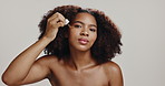 Serum, skincare and face of black woman in studio for anti aging, collagen cosmetics and hyaluronic acid. Dermatology, white background and portrait of person with oils for health, benefits or facial