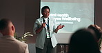 Business woman, presentation and screen with mic for group seminar, conference or convention at office. Female person, speaker or speech with staff for mental health training or wellbeing at workshop