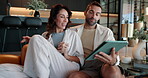 Bonding, relax and couple with tablet, home and watching movies on app in living room and browsing. House, woman and man with tech for streaming, entertainment and smile in lounge, romance or happy
