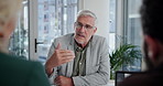 Mature man, CEO and meeting with team in boardroom, documents and discussion for company growth. Leader, executive and business people with tech, listening and review financial performance at agency
