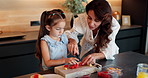Home, mama and girl in kitchen, fruit and help with child development, food and wellness. Family, parent and mother with daughter, healthy and bonding together with breakfast,  cutting and learning