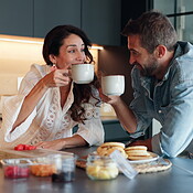 Smile, couple and drink coffee in kitchen with healthy food, nutrition ...
